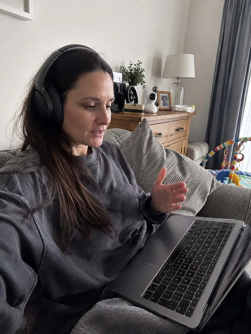 A mum holding her phone showing her store notification