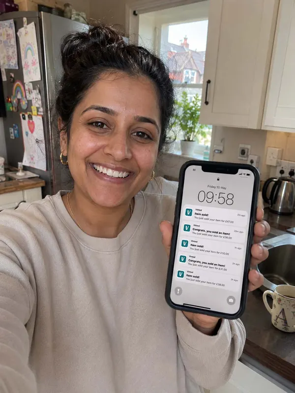 A mum showing her phone with five Vinted sale notifications from a Friday morning, £36 to £50 each.
