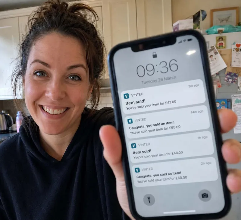 A mum holding her phone showing her store notification